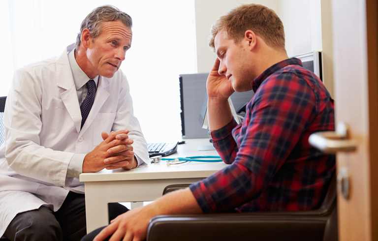 Doctor-consulting-patient-over-varicocele