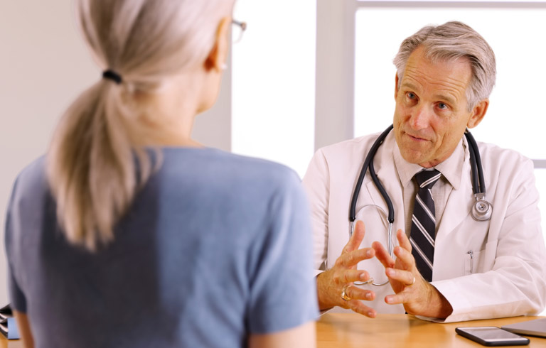 Doctor-preparing-patient-for-sling-procedure