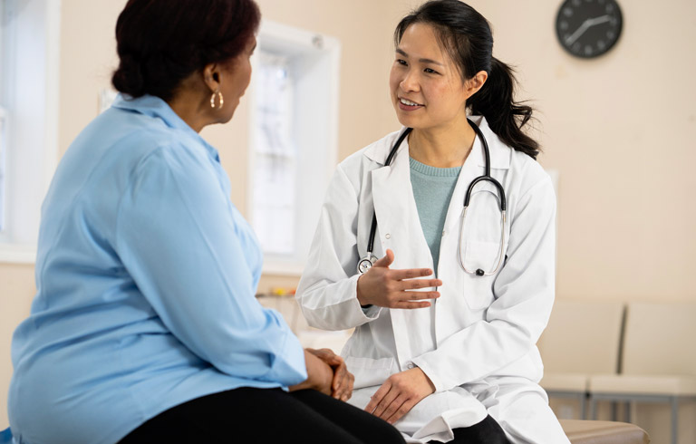Female-doctor-speaking-to-patient-about-upcoming-Blue-Light-Cystoscopy-procedure