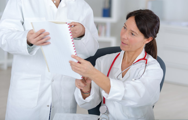 Physician-going-over-artificial-urinary-sphincter-treatment