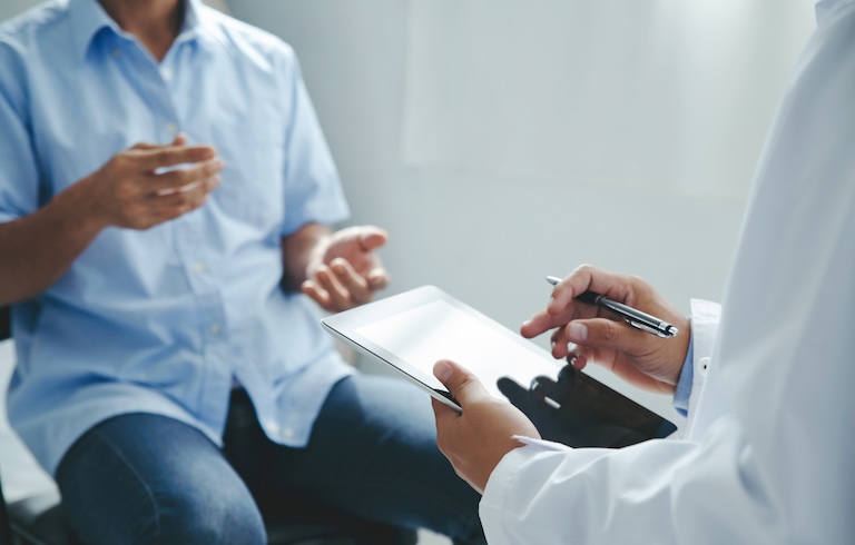 Doctor talking to patients are explaining the treatment of a patient's illness . Health and Medicine concept"
