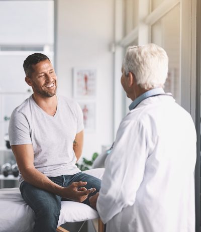 man smiling during visit with doctor